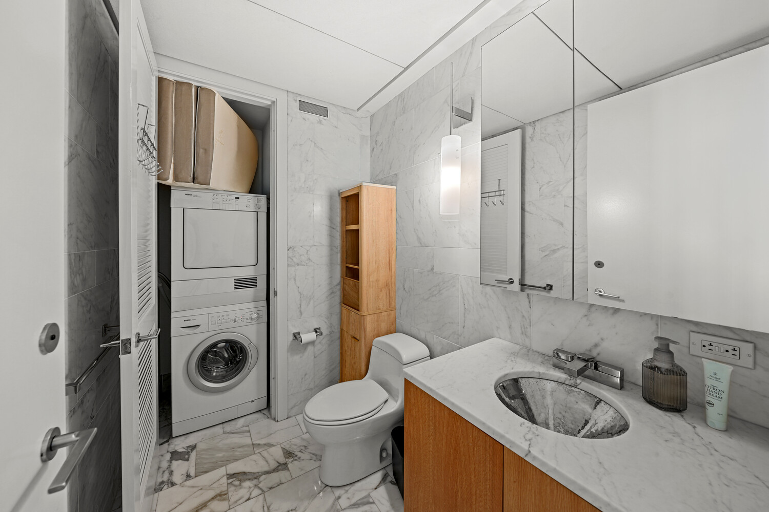 18 West 48th Street, Unit 22A Manhattan, NY 10036 - Photo 7 of 9 a bathroom with a sink a toilet and shower