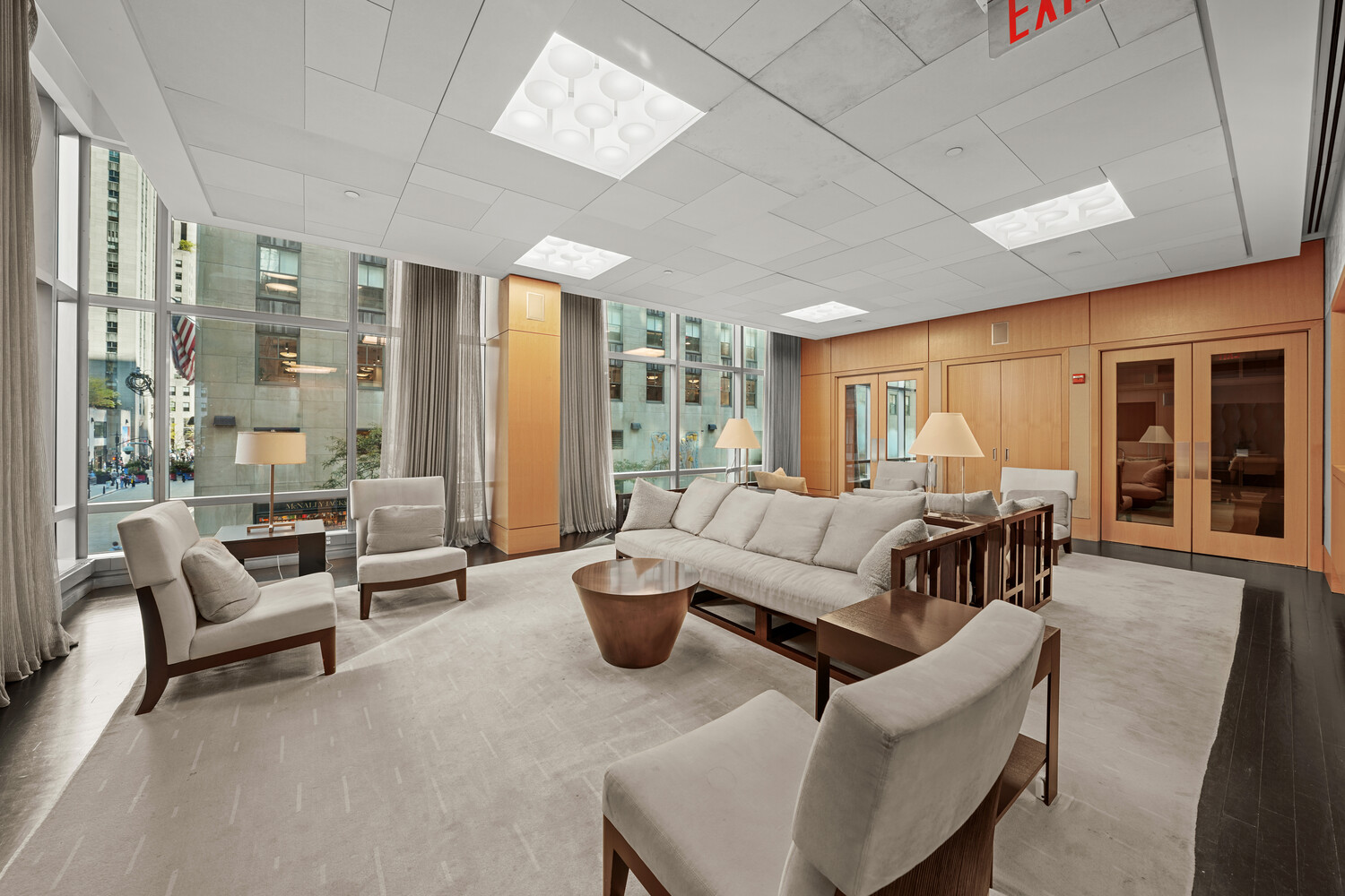 18 West 48th Street, Unit 22A Manhattan, NY 10036 - Photo 8 of 9 a living room with furniture and a large window