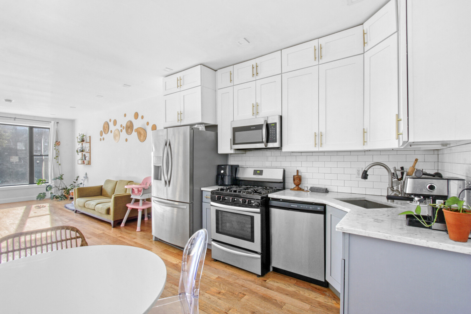 1353 Saint Marks Avenue, Unit 1 Brooklyn, NY 11233 - Photo 1 of 17 a kitchen with stainless steel appliances a white stove top oven and a refrigerator