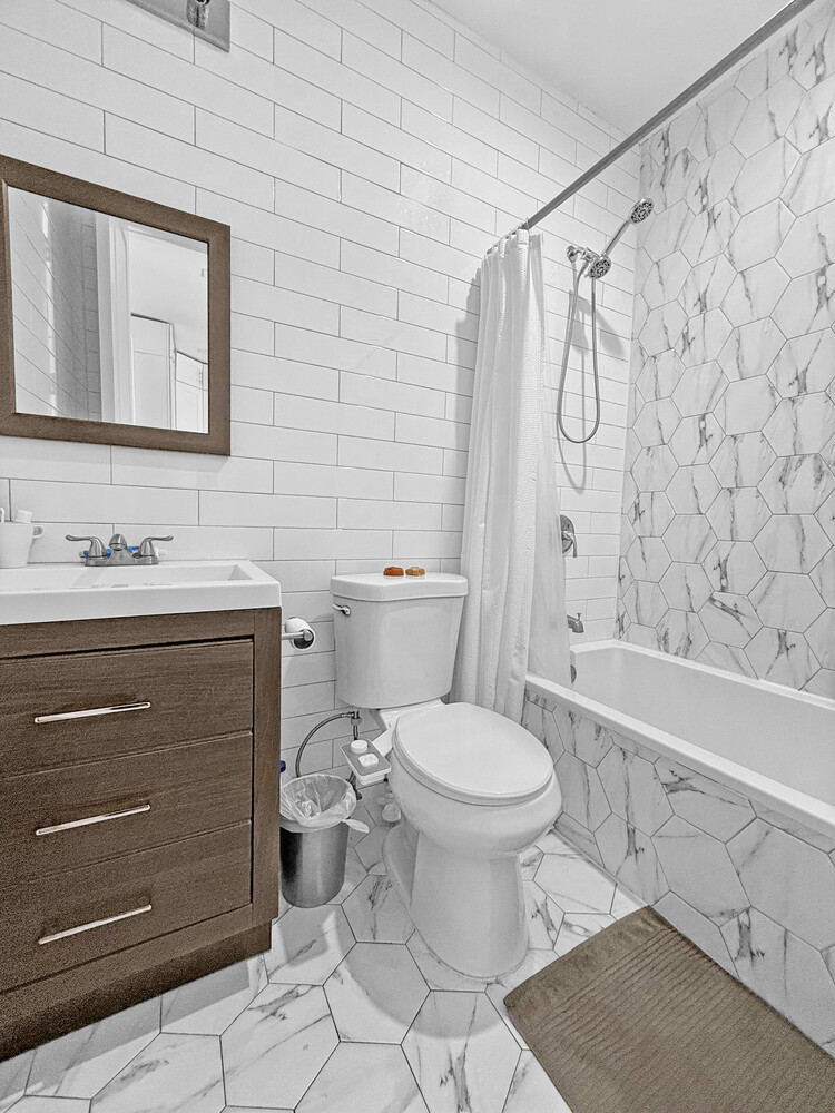 1353 Saint Marks Avenue, Unit 1 Brooklyn, NY 11233 - Photo 11 of 17 a bathroom with a sink toilet and shower