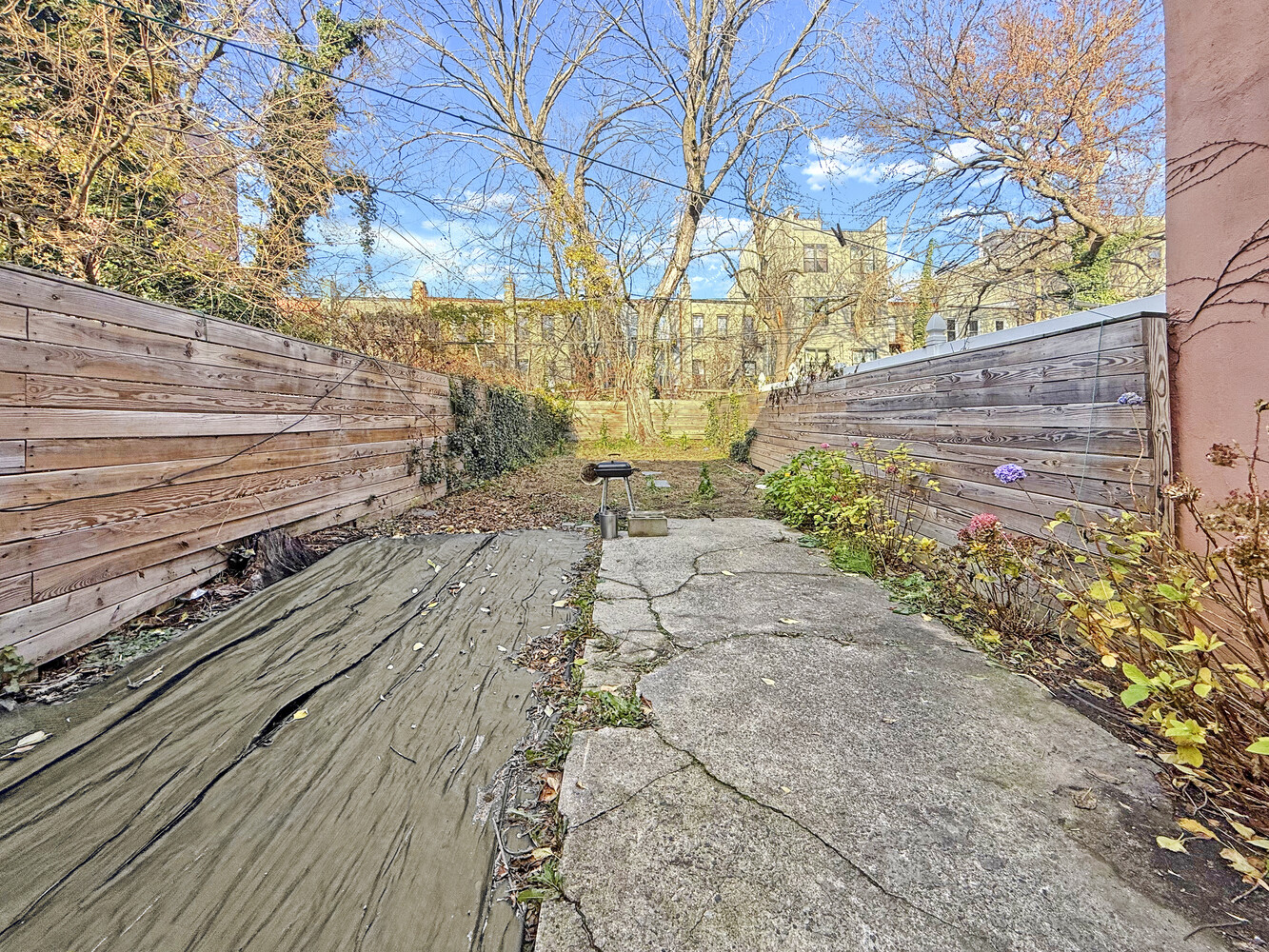 1353 Saint Marks Avenue, Unit 1 Brooklyn, NY 11233 - Photo 15 of 17 a view of a yard with wooden fence