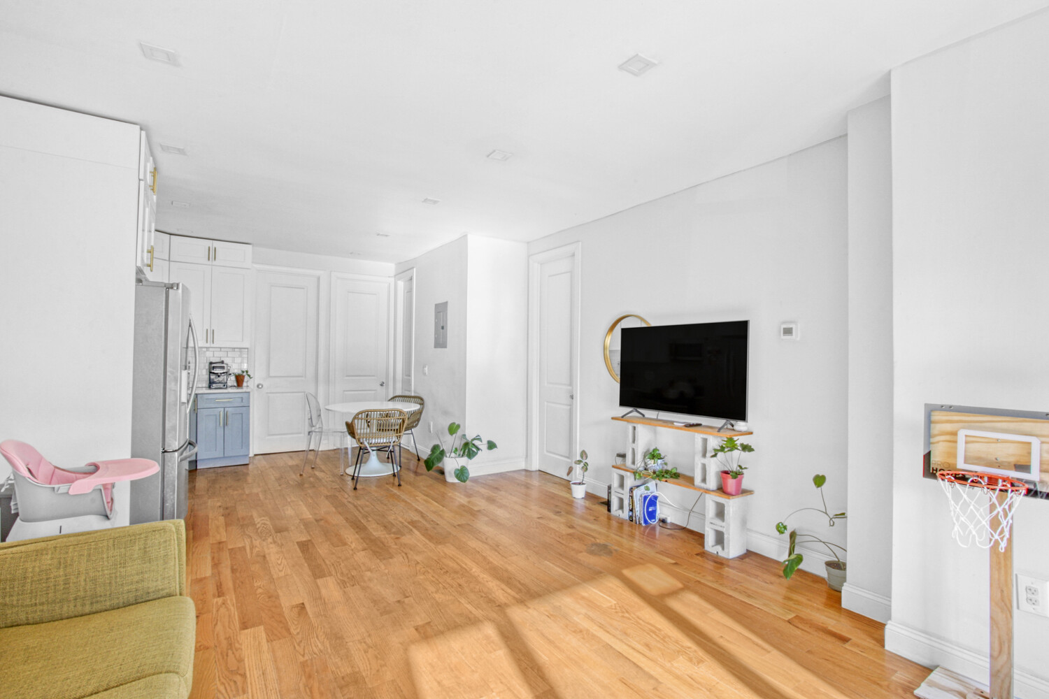 1353 Saint Marks Avenue, Unit 1 Brooklyn, NY 11233 - Photo 4 of 17 a bedroom with a bed and a flat screen tv