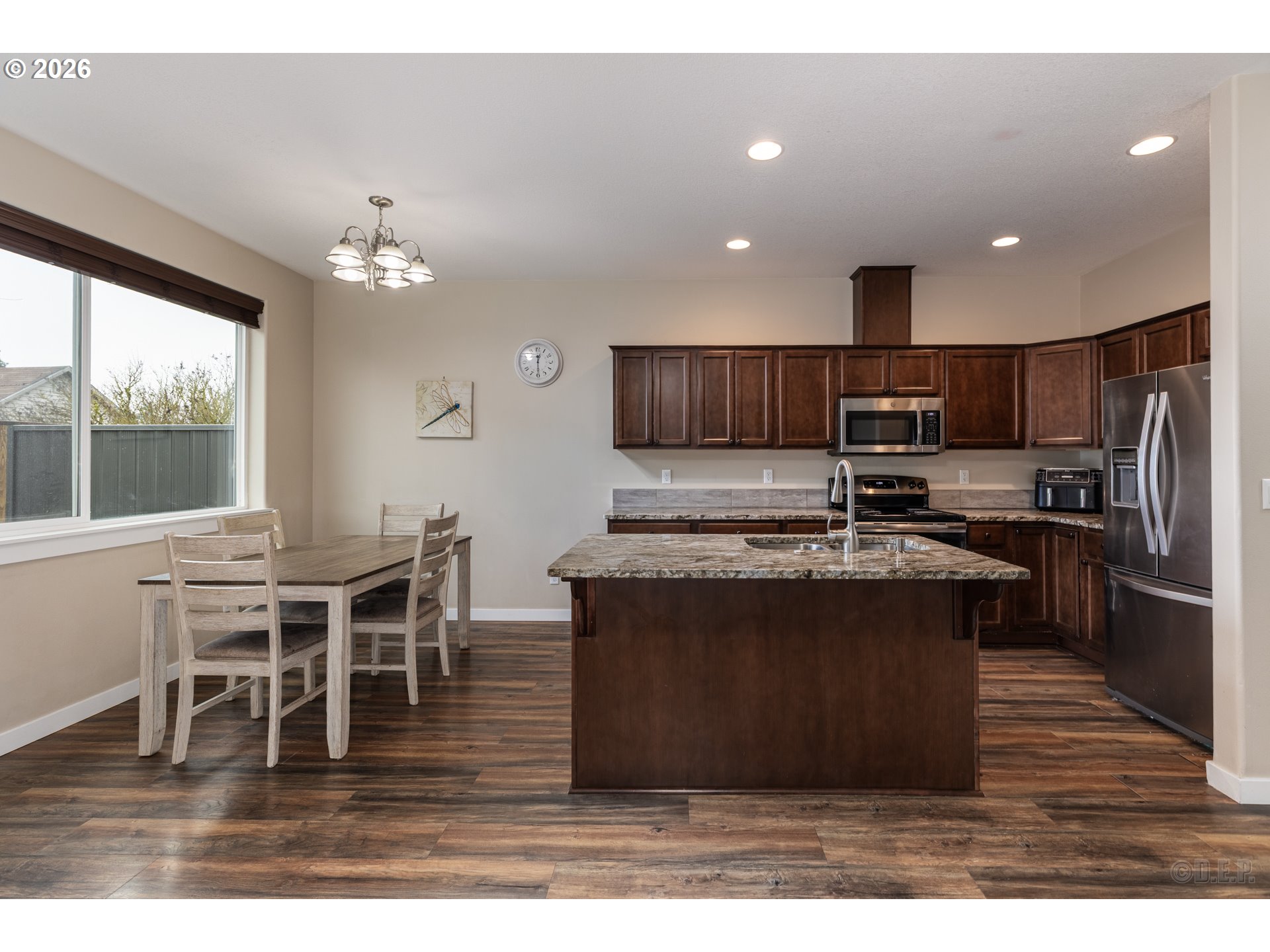 193 South 2nd Street St. Helens, OR 97051 - Photo 6 of 23 a kitchen with stainless steel appliances granite countertop a stove top oven a sink a dining table and chairs