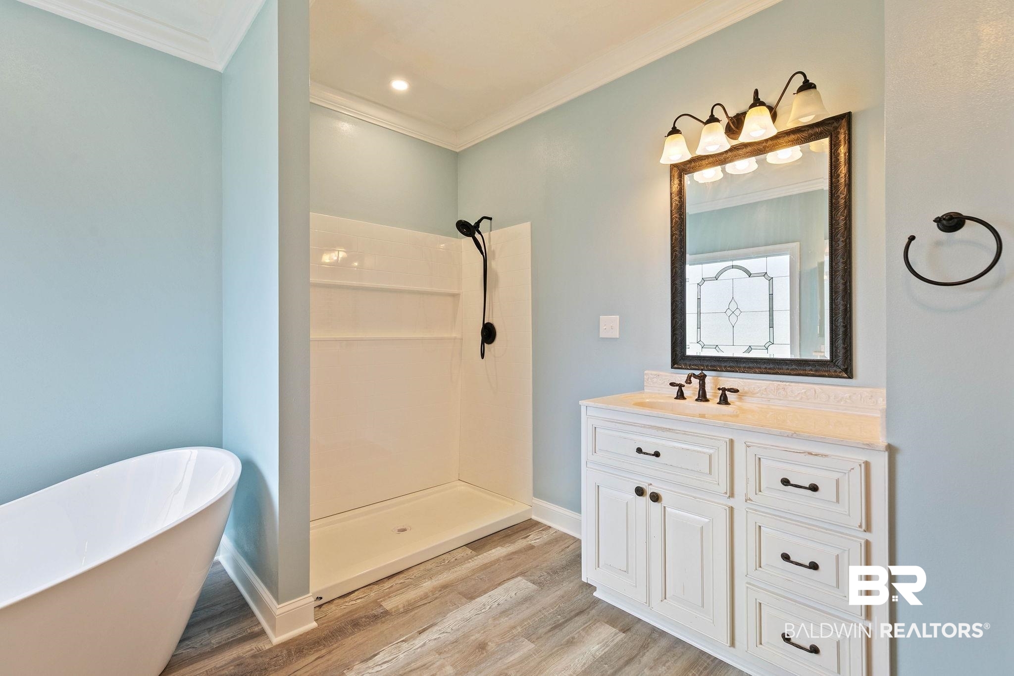 3668 Claridge Road North Mobile, AL 36608 - Photo 53 of 100 Full bathroom featuring vanity, crown molding, a soaking tub, a stall shower, and light wood-type flooring