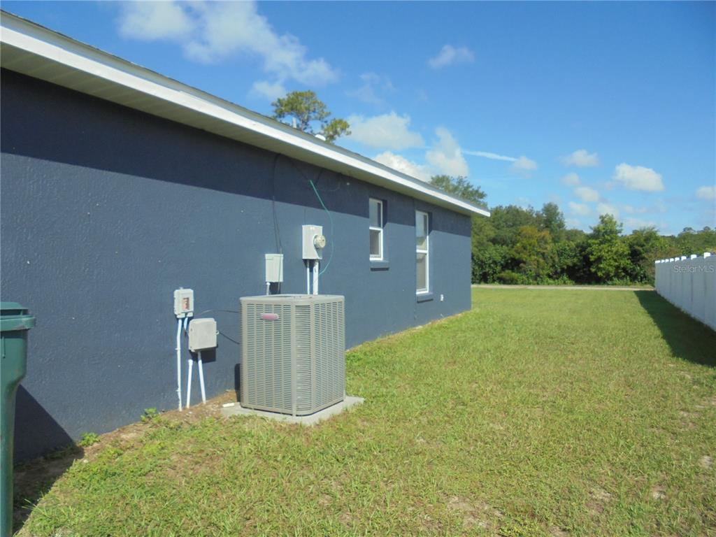 1509 Northeast 46th Road Ocala, FL 34470 - Photo 2 of 28 a backyard of a house with lots of green space
