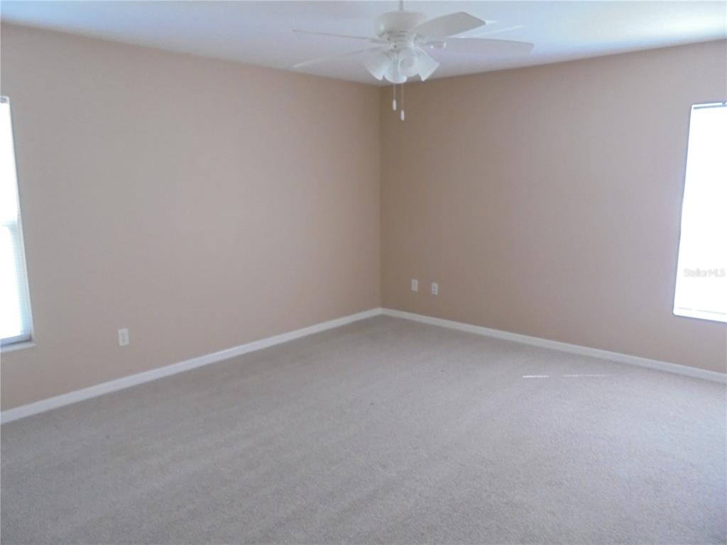 1509 Northeast 46th Road Ocala, FL 34470 - Photo 24 of 28 an empty room with a window and a fan