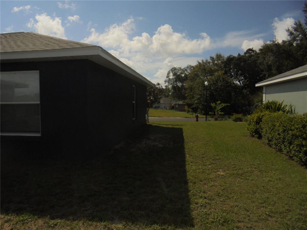 1509 Northeast 46th Road Ocala, FL 34470 - Photo 7 of 28 a backyard of a house with lots of green space lake and mountain view