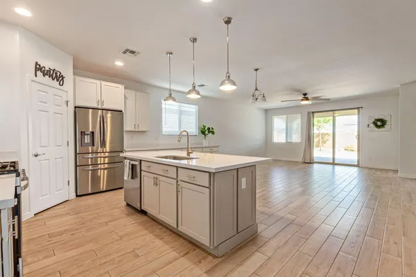 a kitchen with a sink stove and refrigerator