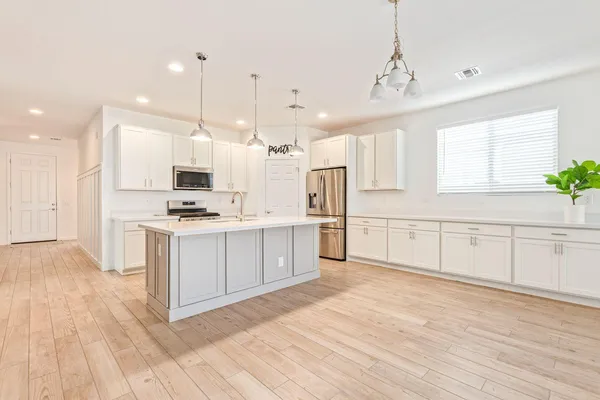 a kitchen with white cabinets and white appliances