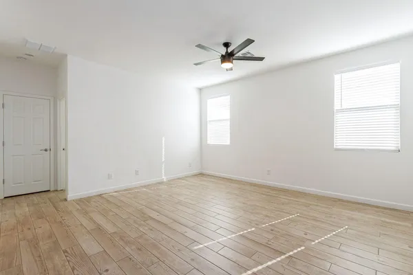 wooden floor in an empty room with a window