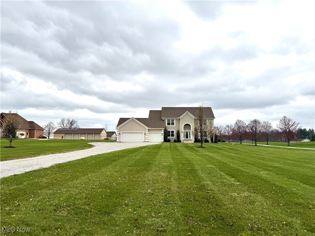 3450 Secrest Road Wooster, OH 44691 - Photo 6 of 34 View of front of house with an attached garage, driveway, and a front yard