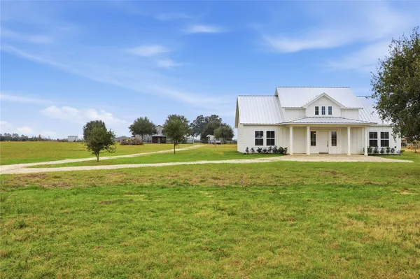 a front view of a house with a big yard