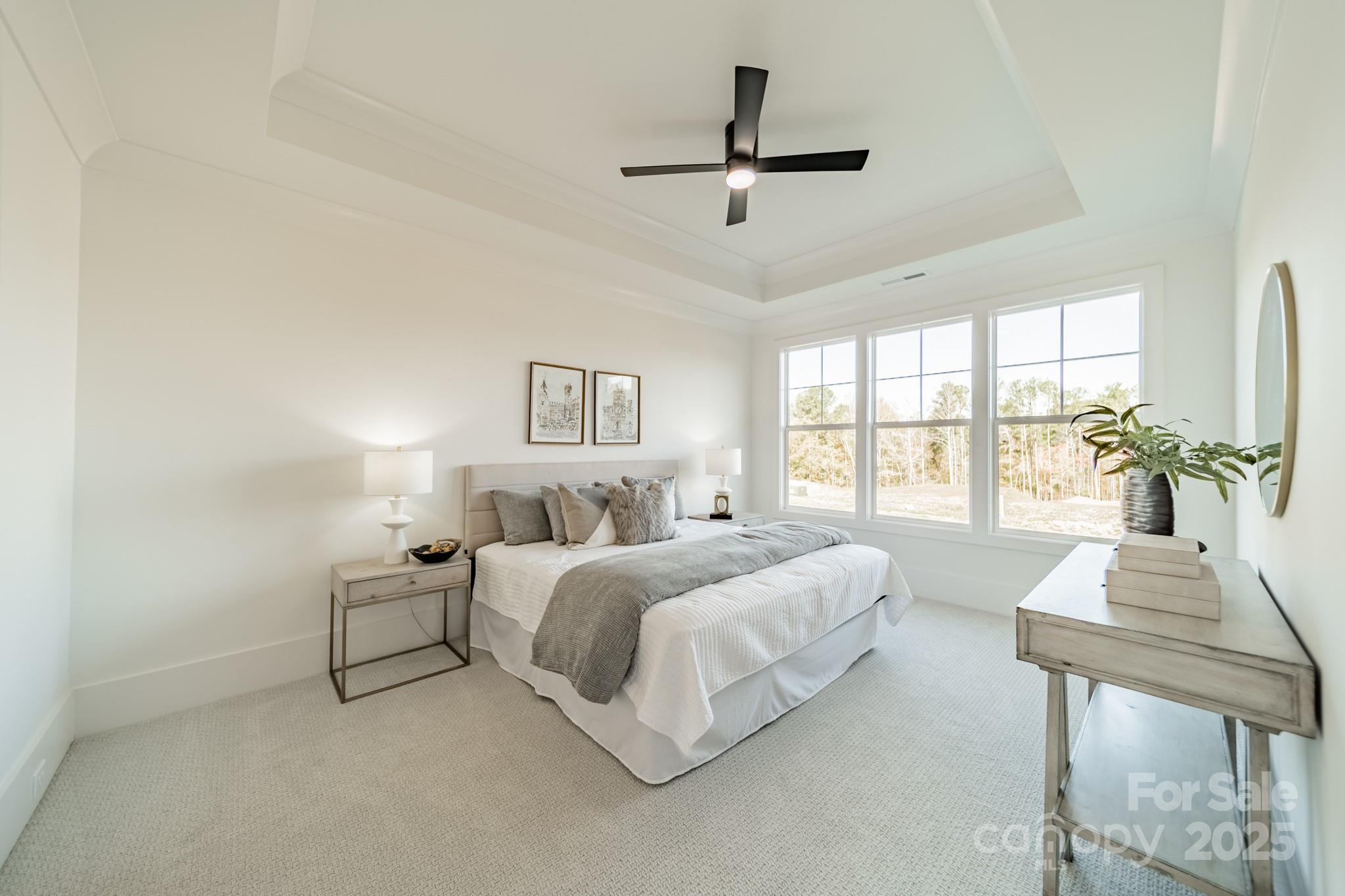 19032 Newburg Hill Road, Unit 23 Davidson, NC 28036 - Photo 27 of 39 a bedroom with a bed a chandelier and a window