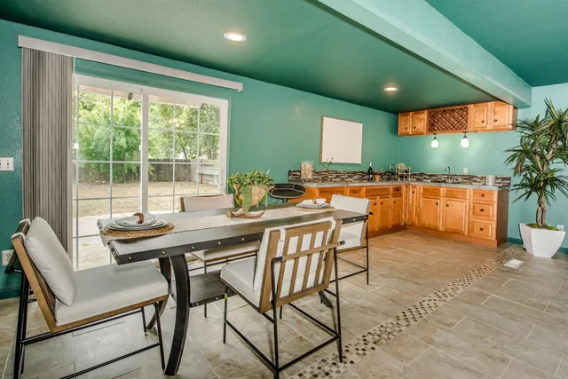 a spacious bathroom with a granite countertop sink and a mirror