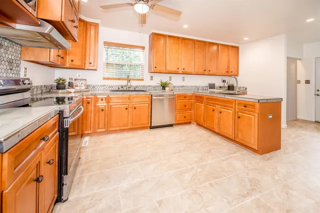 a kitchen with sink cabinets and refrigerator