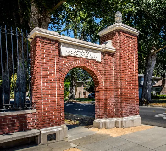 a spacious bedroom with a bed and wooden floor