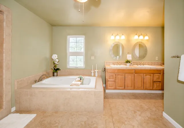 a spacious bathroom with a bathtub and a shower