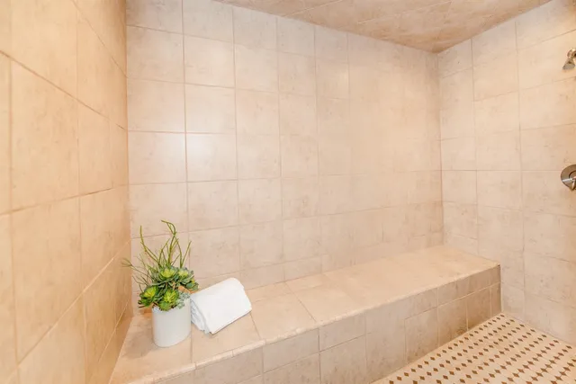 a spacious bathroom with a sink and a mirror
