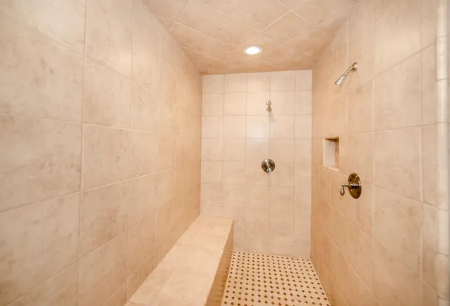 a bathroom with a bathtub and a shower