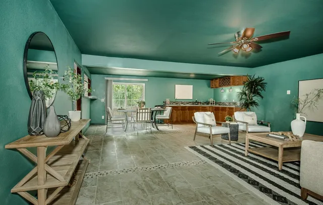 a spacious bedroom with a bed and a chandelier