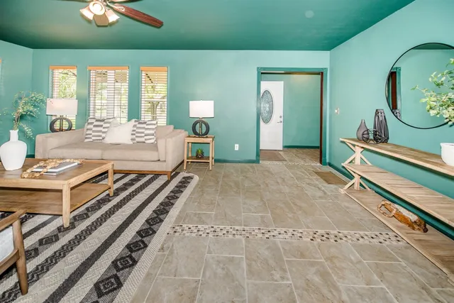 a living room with furniture and a potted plant