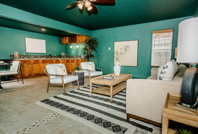 a living room with furniture a rug and a large window