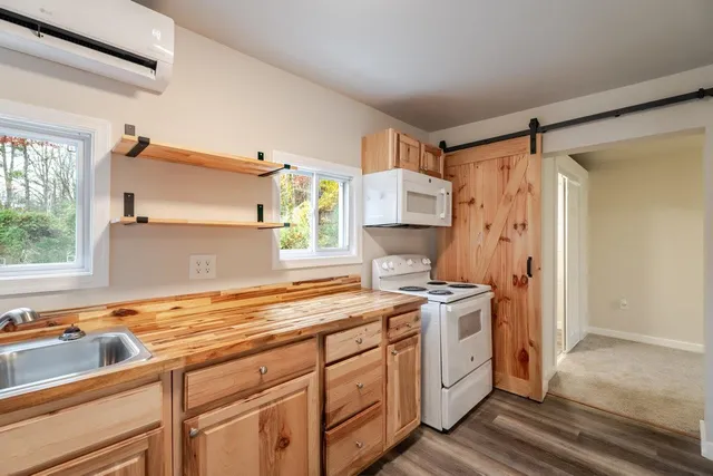 a kitchen with a stove a sink and a refrigerator