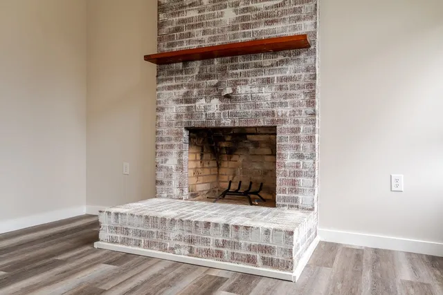 a bedroom with a bed and a fireplace