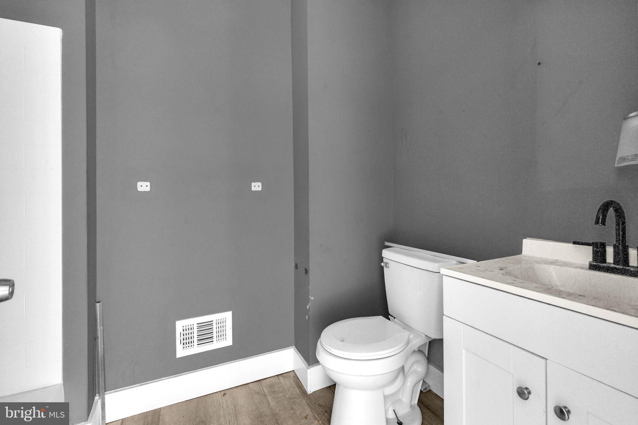 2315 East Madison Street Baltimore, MD 21205 - Photo 14 of 18 a bathroom with a sink and a toilet