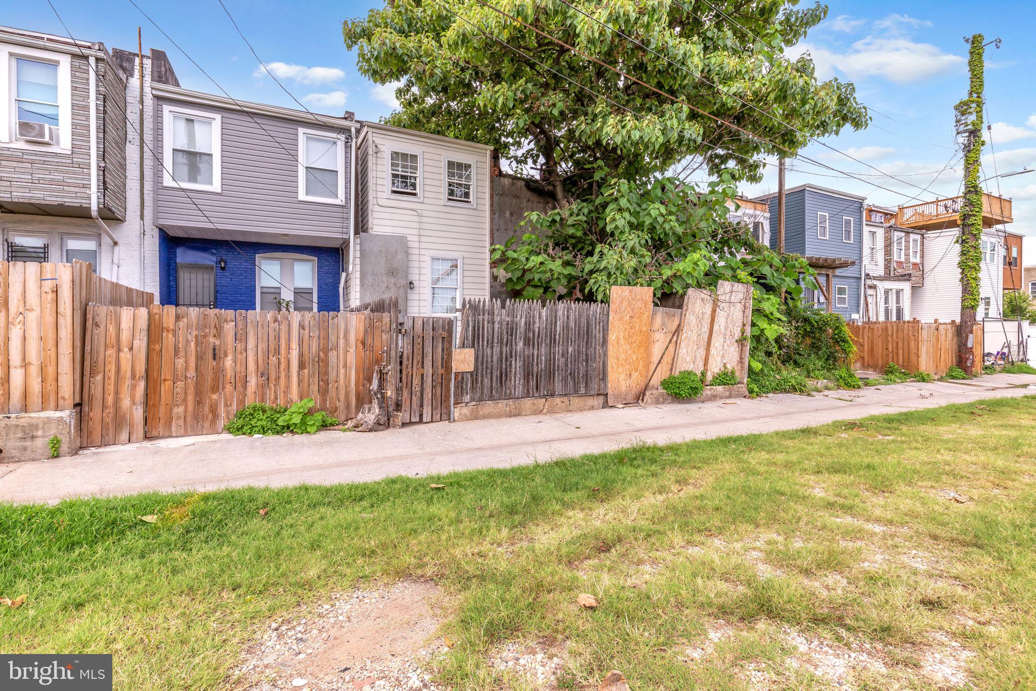 2315 East Madison Street Baltimore, MD 21205 - Photo 18 of 18 a view of a brick house with a yard and plants