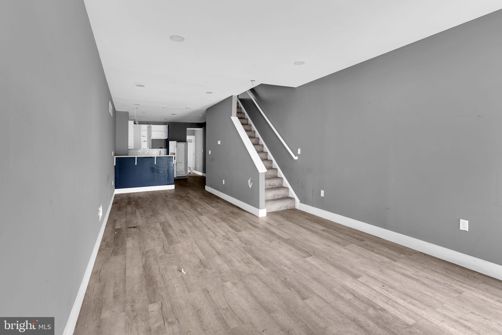 2315 East Madison Street Baltimore, MD 21205 - Photo 5 of 18 a view of livingroom with stairs and stairs