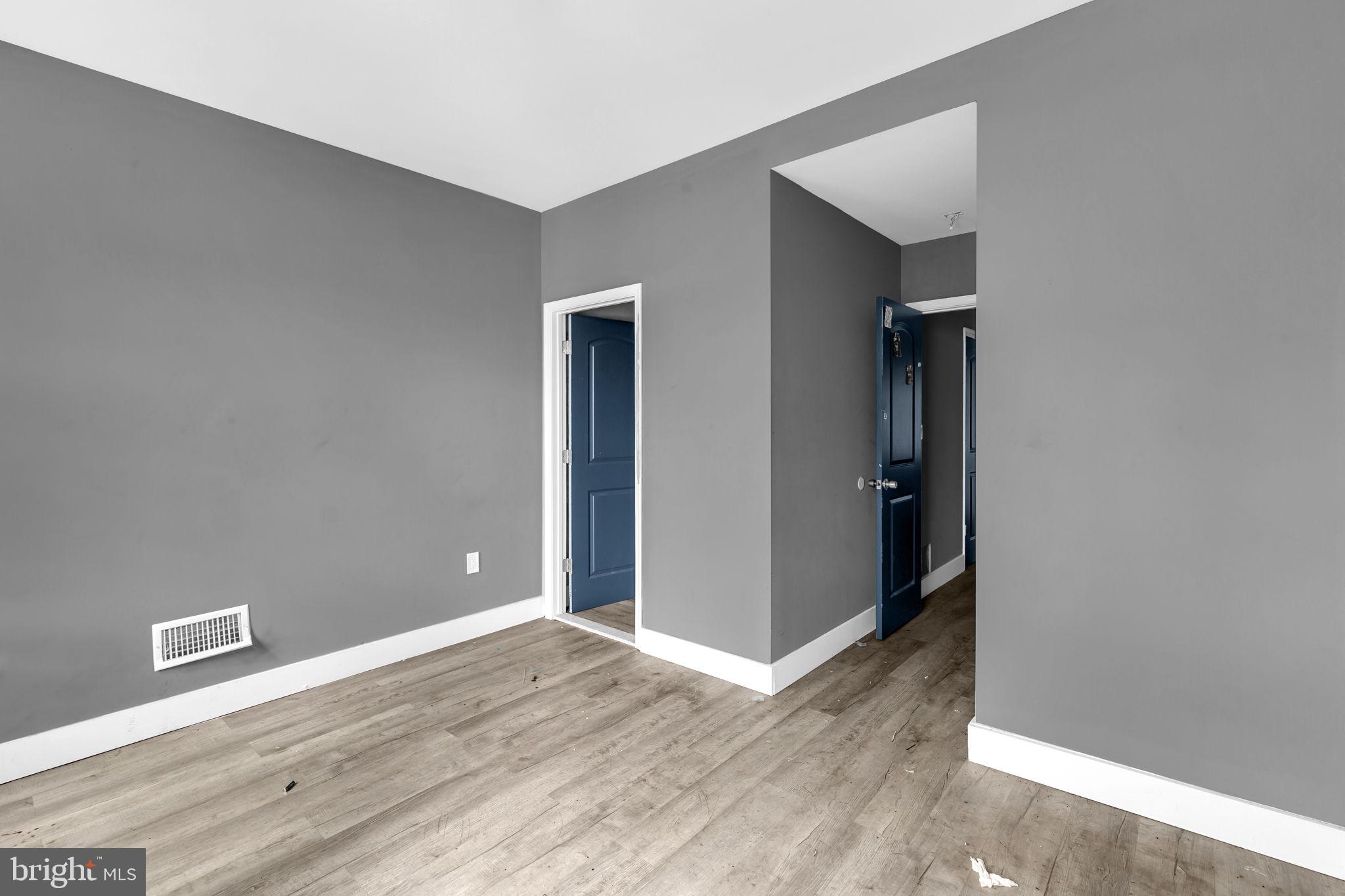 2315 East Madison Street Baltimore, MD 21205 - Photo 9 of 18 an empty room with wooden floor and closet
