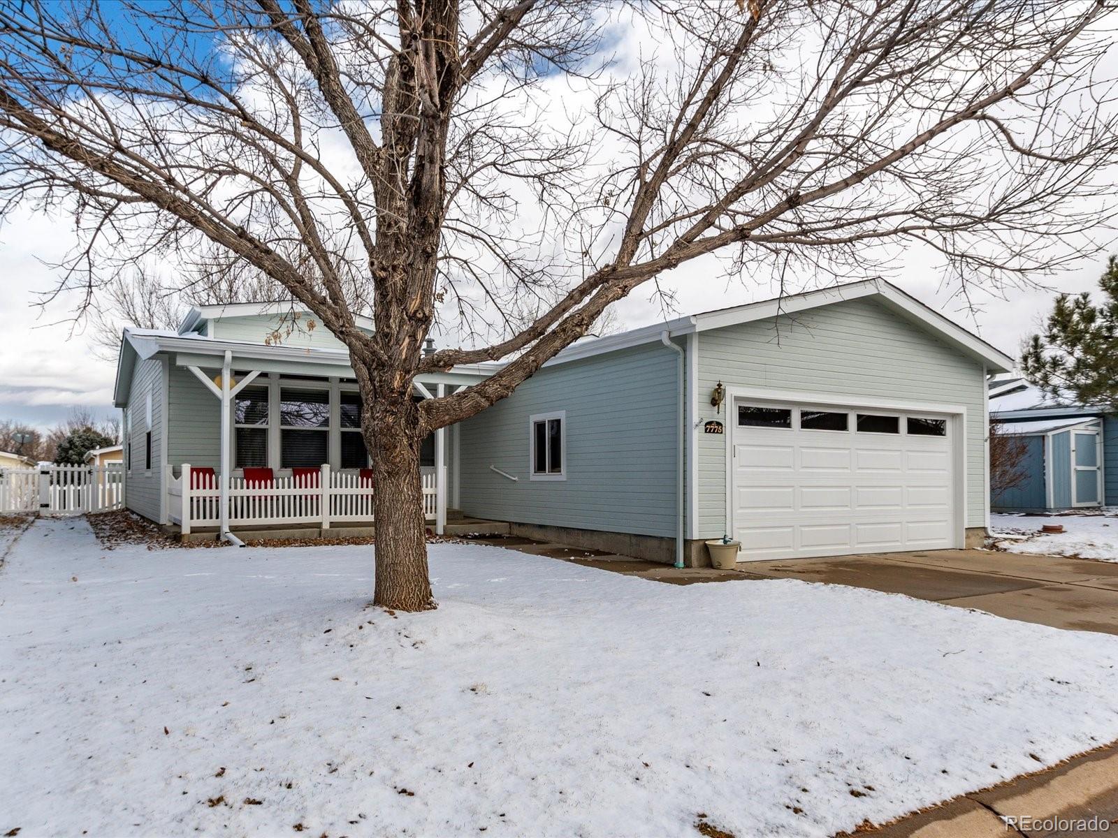 7775 Sage Green Frederick, CO 80530 - Photo 1 of 40 a view of a house with a large tree in front of it