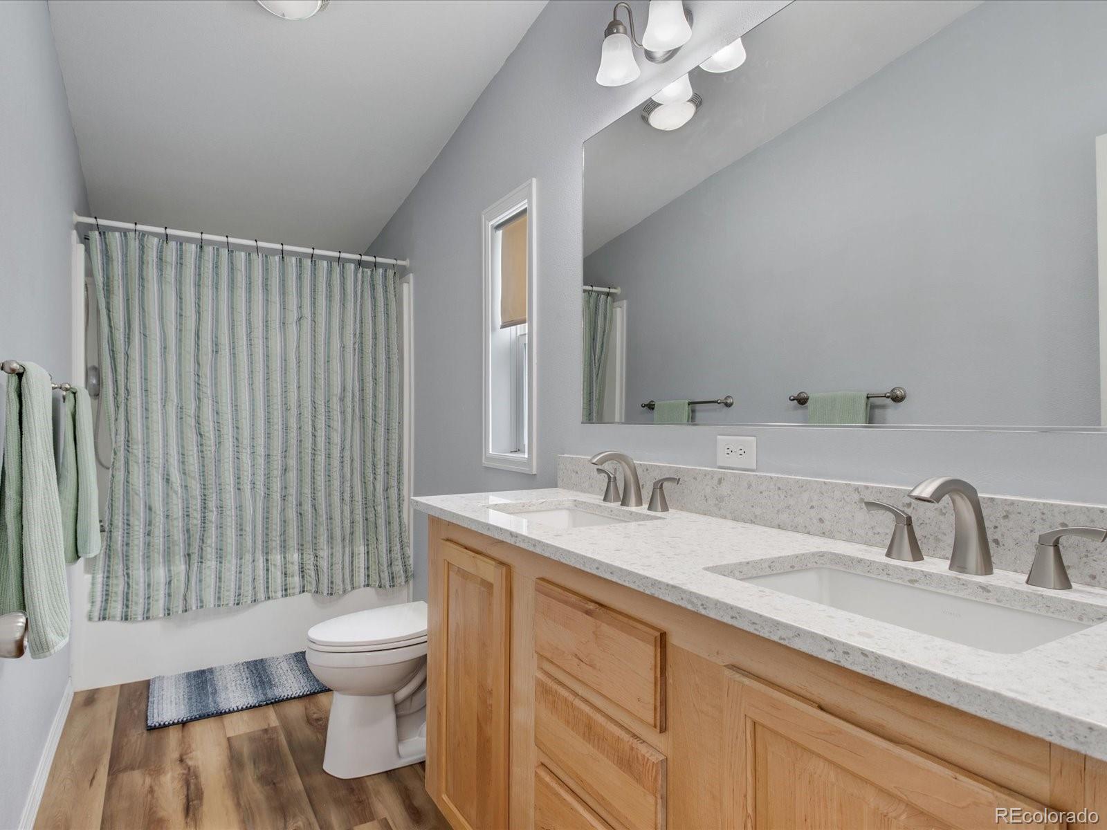 7775 Sage Green Frederick, CO 80530 - Photo 12 of 40 a bathroom with a sink a toilet and vanity