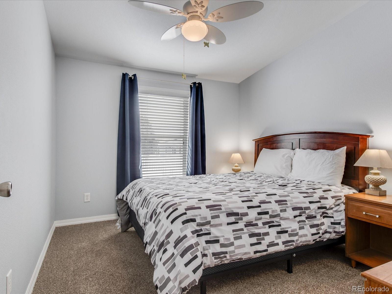 7775 Sage Green Frederick, CO 80530 - Photo 13 of 40 a bedroom with a bed and a chandelier
