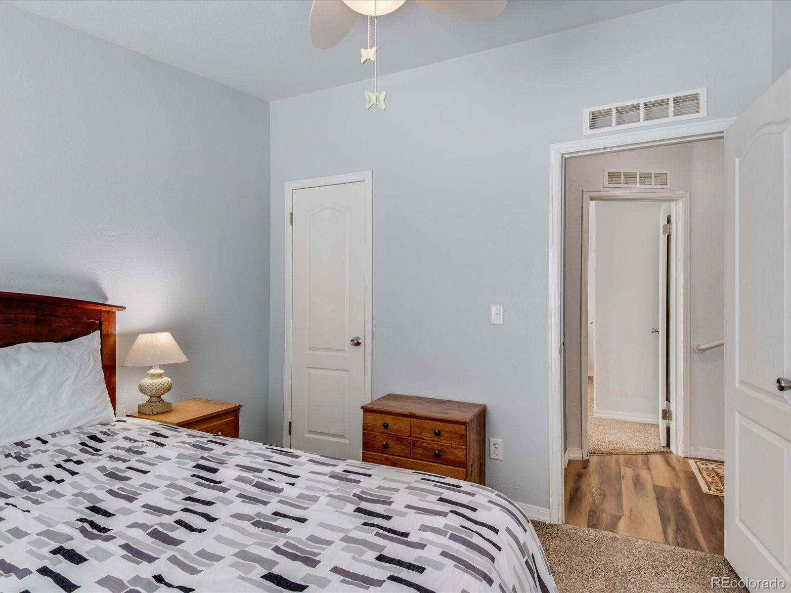 7775 Sage Green Frederick, CO 80530 - Photo 14 of 40 a bedroom with a bed and a lamp