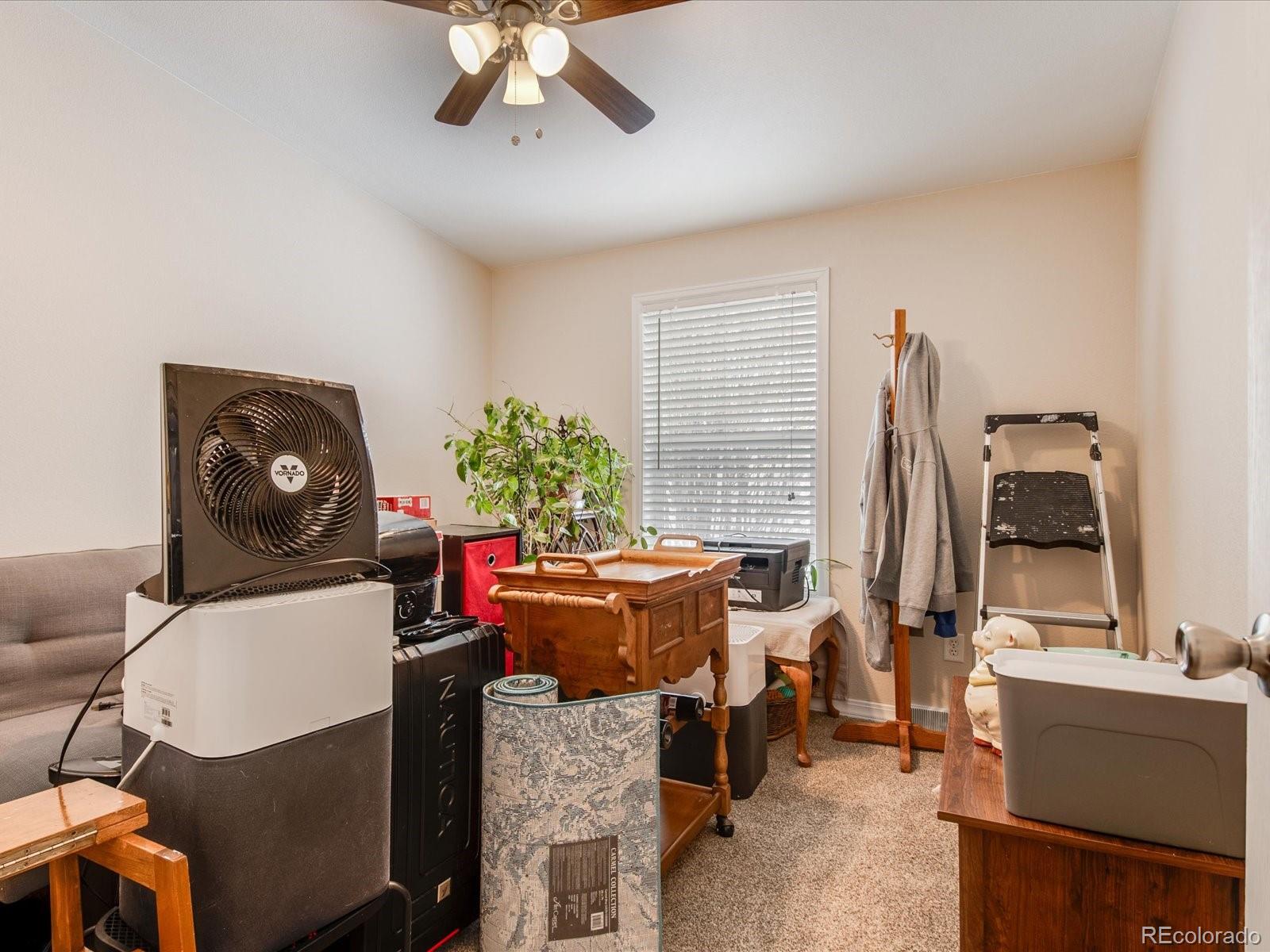 7775 Sage Green Frederick, CO 80530 - Photo 16 of 40 a living room with furniture and a large window