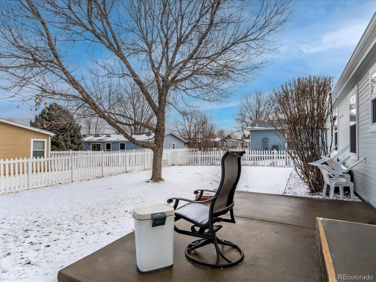 7775 Sage Green Frederick, CO 80530 - Photo 19 of 40 a view of a backyard with furniture and snow