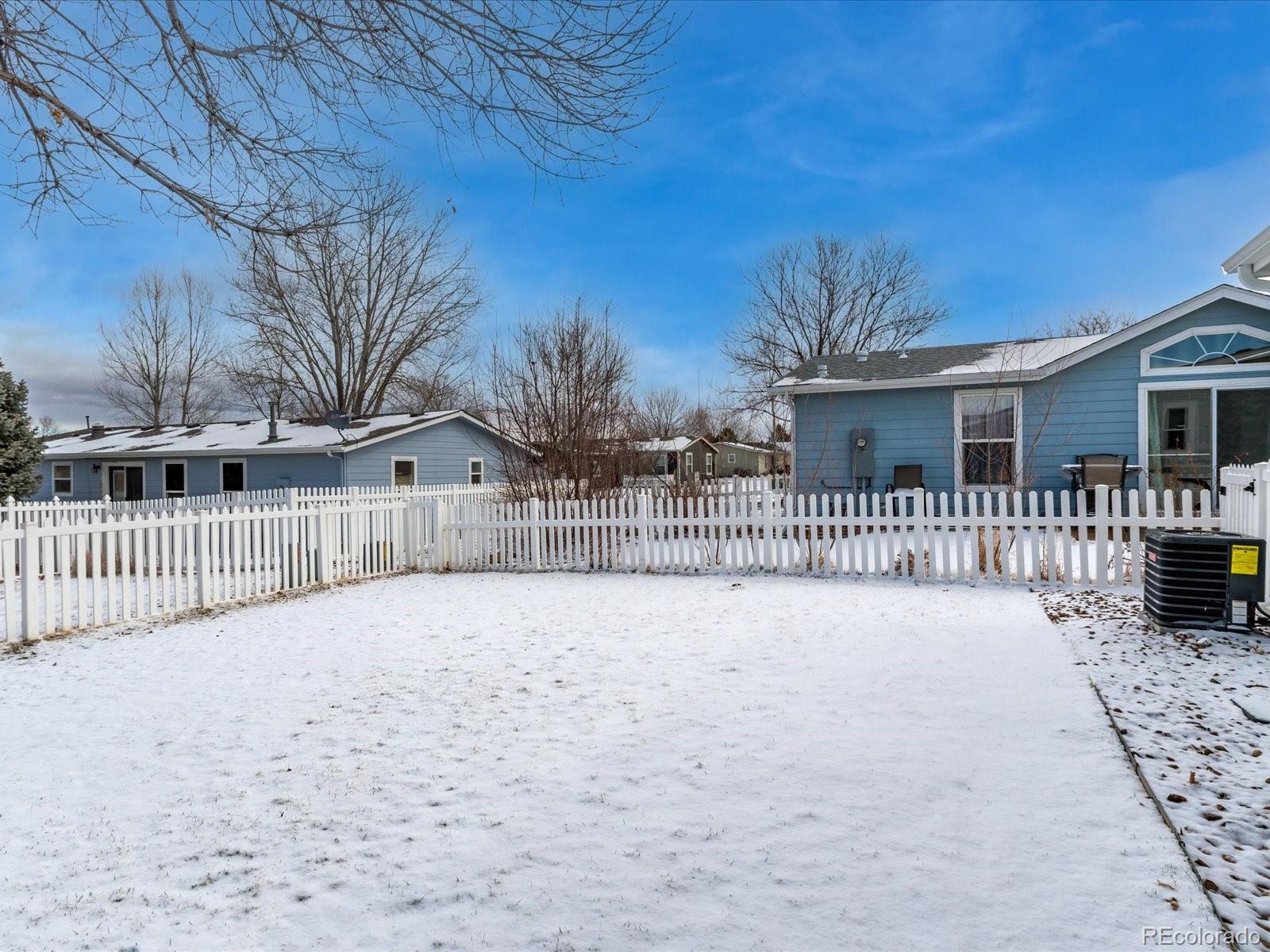 7775 Sage Green Frederick, CO 80530 - Photo 20 of 40 a view of a house with a wooden fence