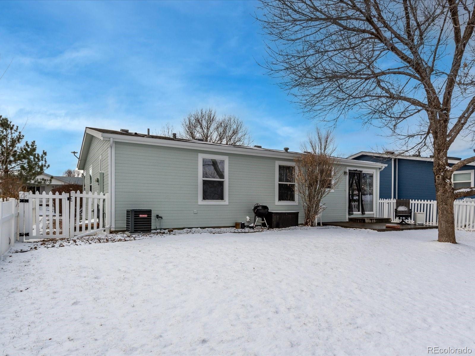 7775 Sage Green Frederick, CO 80530 - Photo 21 of 40 a view of a house with a snow in the yard