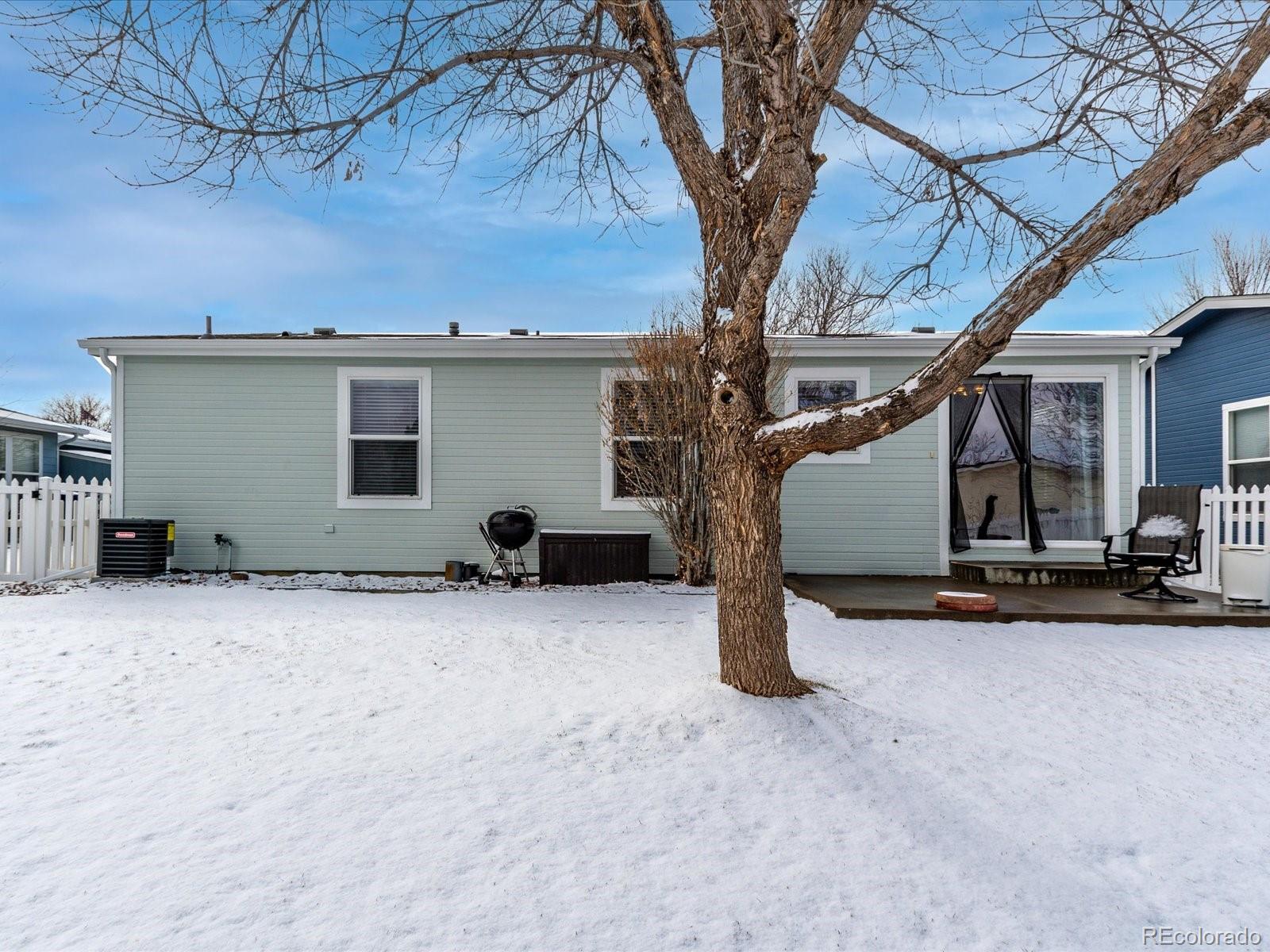 7775 Sage Green Frederick, CO 80530 - Photo 22 of 40 a view of a house with a snow in the yard