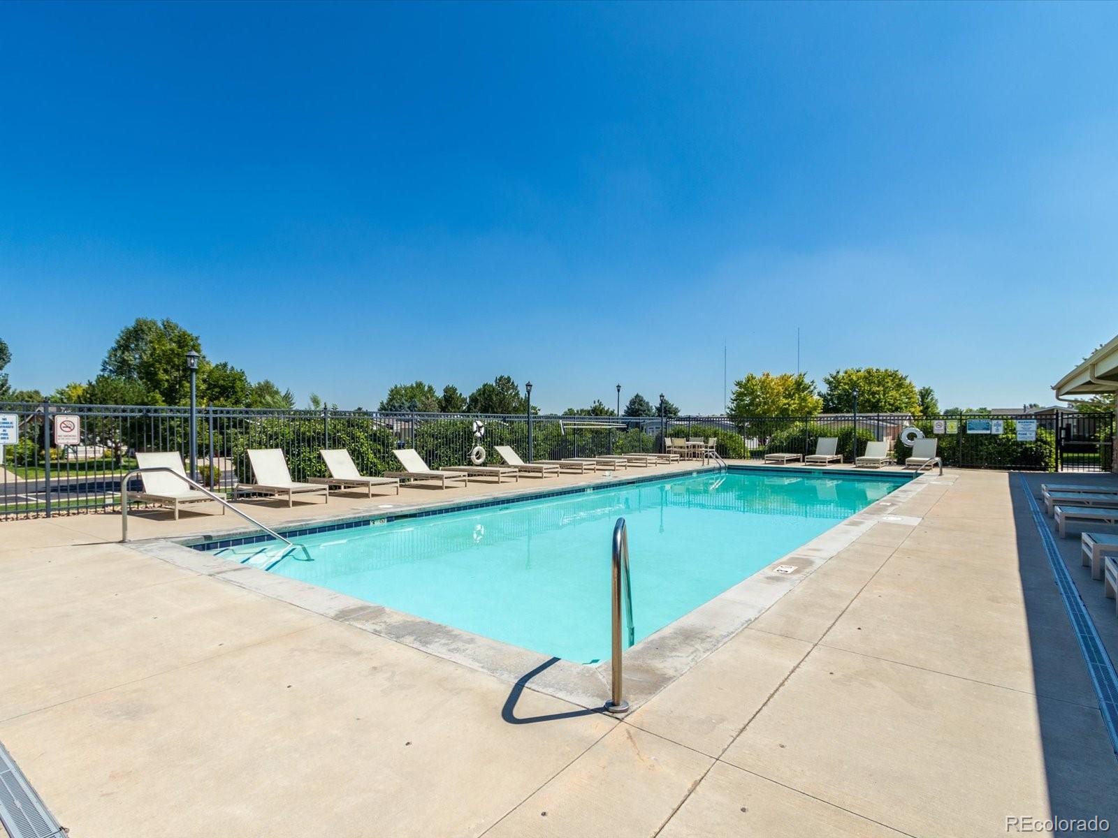 7775 Sage Green Frederick, CO 80530 - Photo 38 of 40 a view of a swimming pool with lounge chair