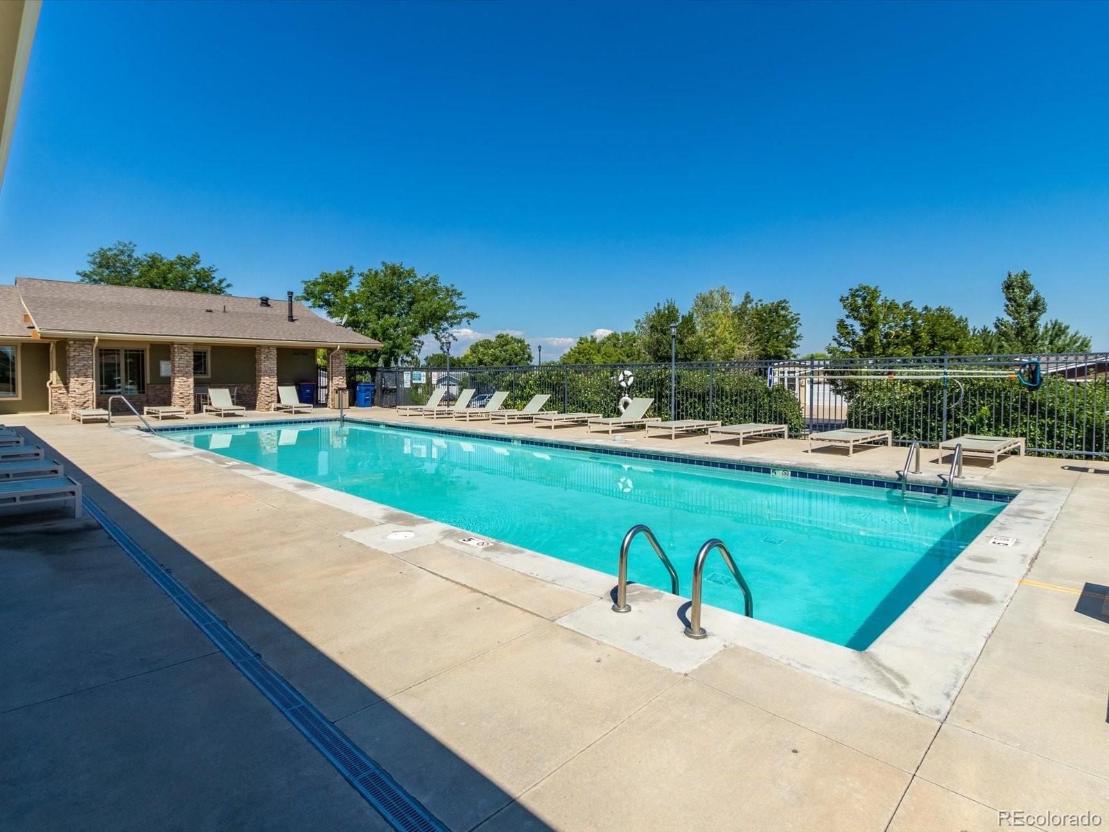 7775 Sage Green Frederick, CO 80530 - Photo 39 of 40 a view of swimming pool with outdoor seating and lake view