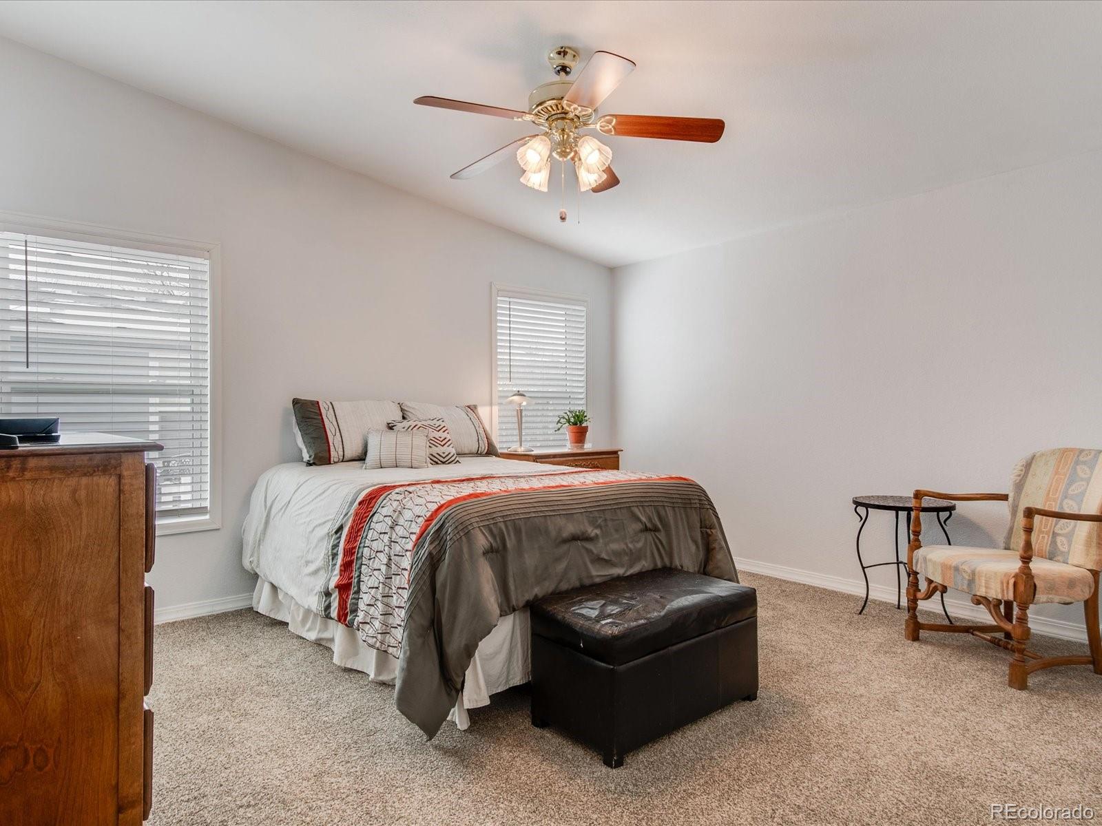 7775 Sage Green Frederick, CO 80530 - Photo 10 of 40 a spacious bedroom with a bed and a chandelier