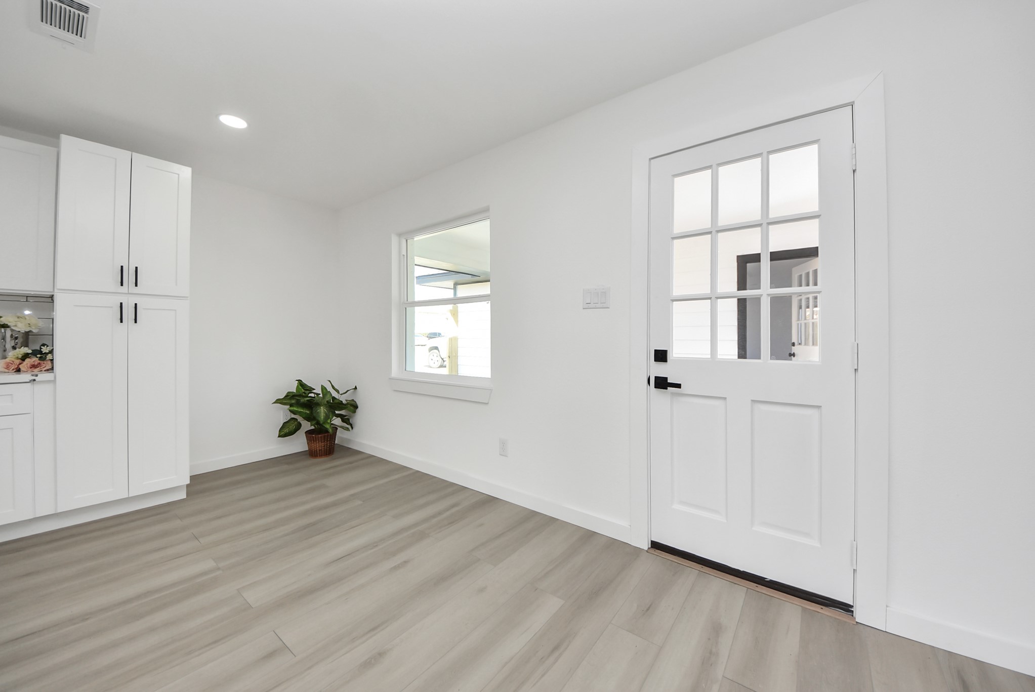 2701 Mustang Road Alvin, TX 77511 - Photo 16 of 45 an empty room with wooden floor and windows
