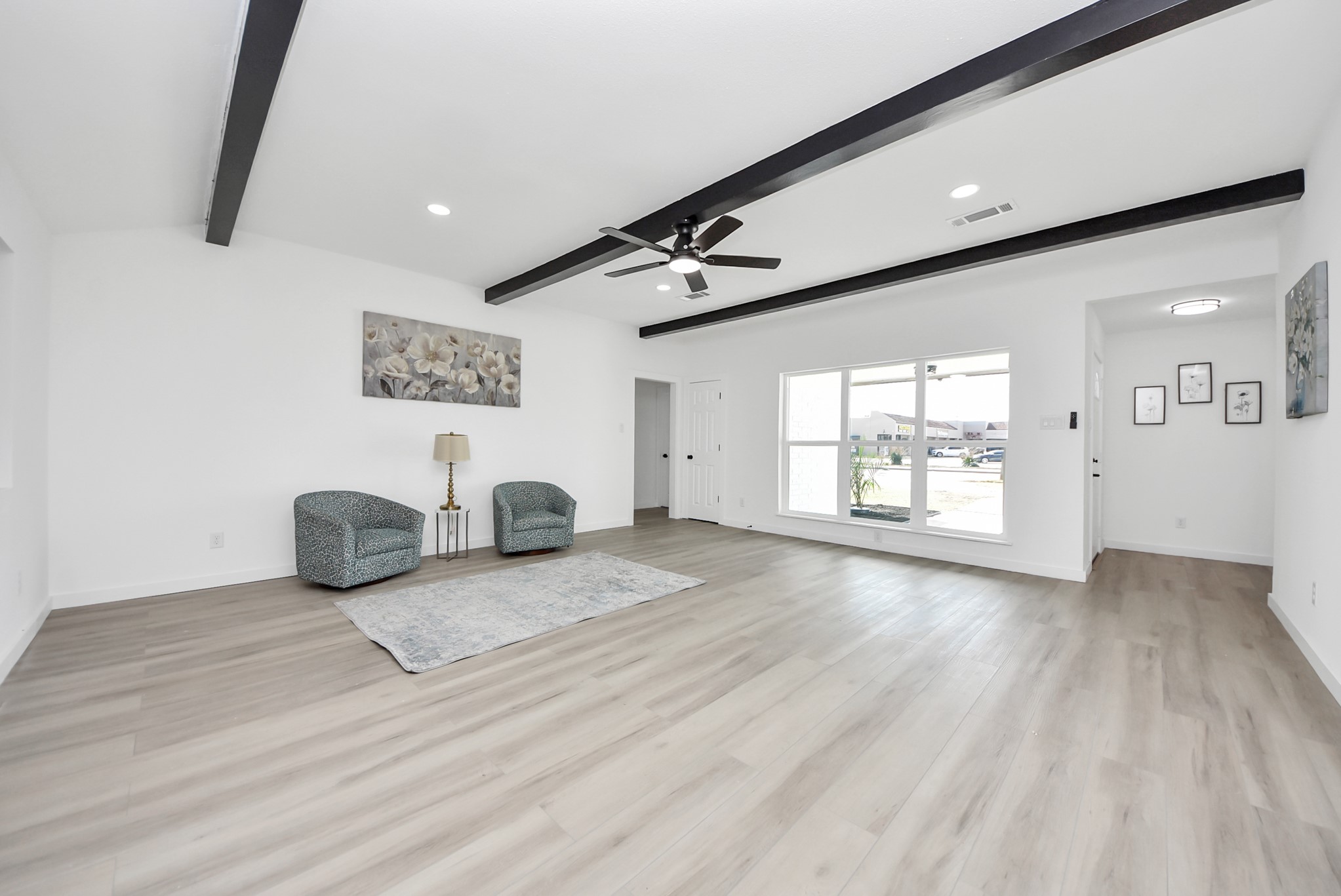 2701 Mustang Road Alvin, TX 77511 - Photo 7 of 45 a view of an empty room with wooden floor and a window