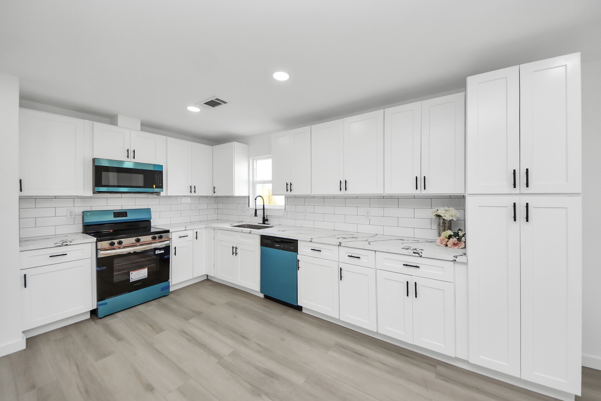 2701 Mustang Road Alvin, TX 77511 - Photo 10 of 45 a kitchen with granite countertop white cabinets and stainless steel appliances