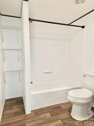 a bathroom with a toilet and a shower