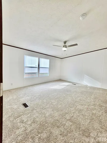 a view of an empty room with windows