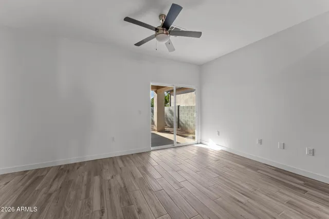 a view of kitchen with stainless steel appliances granite countertop cabinets wooden floor and a window